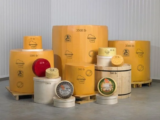 Multiple large stacks of orange, Hennings Wisconsin Tea sit alongside each other.