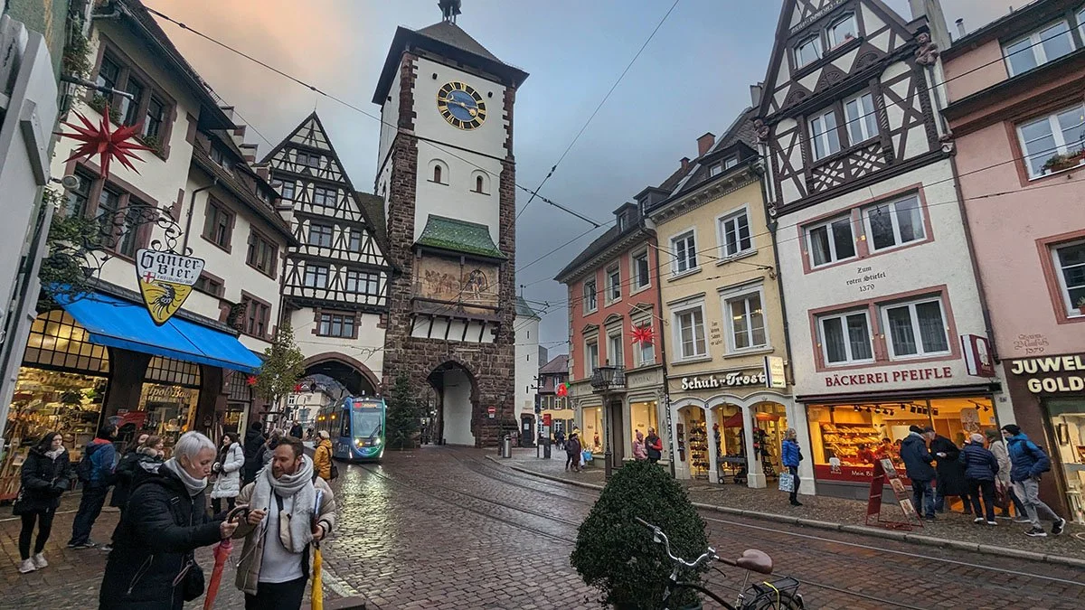 Cobblestoned streets and bright coloured buildings at the heart of Freiburg, Germany.