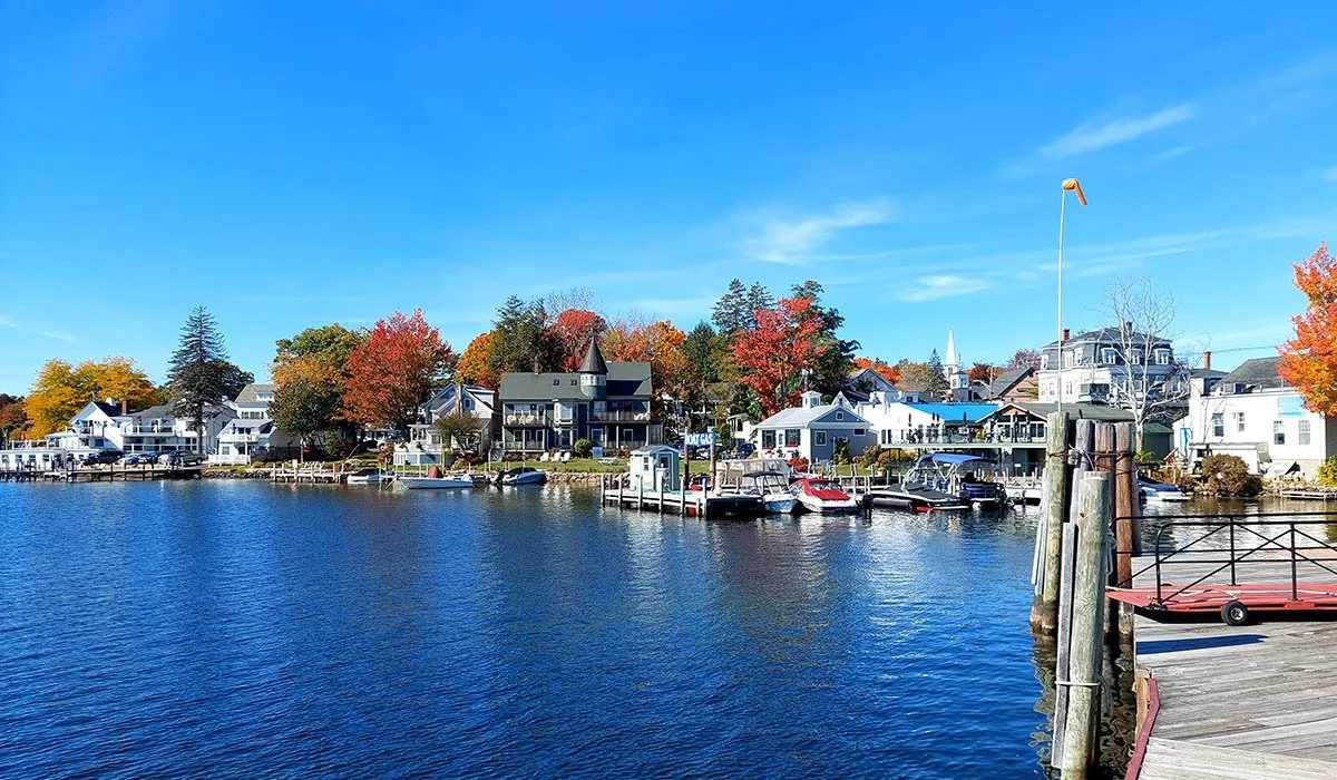 Docks float on the waters with bright, fall colours in the back in Wolfeboro, New Hampshire.