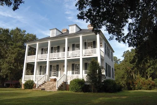 A white house with open balconies at the Hopsewee Plantation.