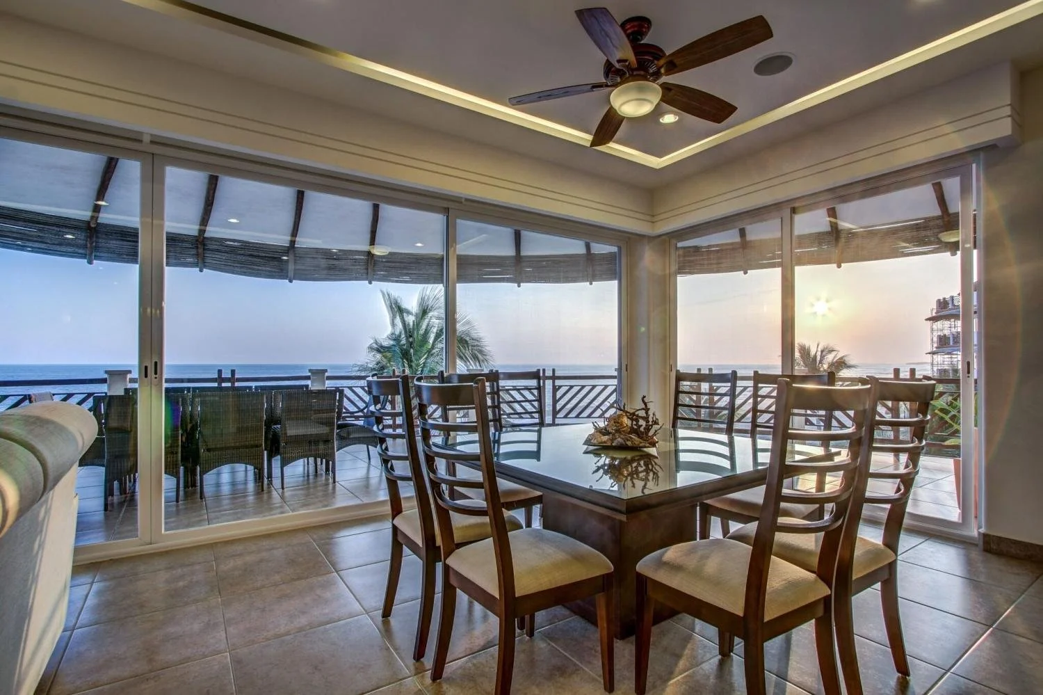 The sunset over a balcony and table at Vivo Resorts in Puerto Escondido.