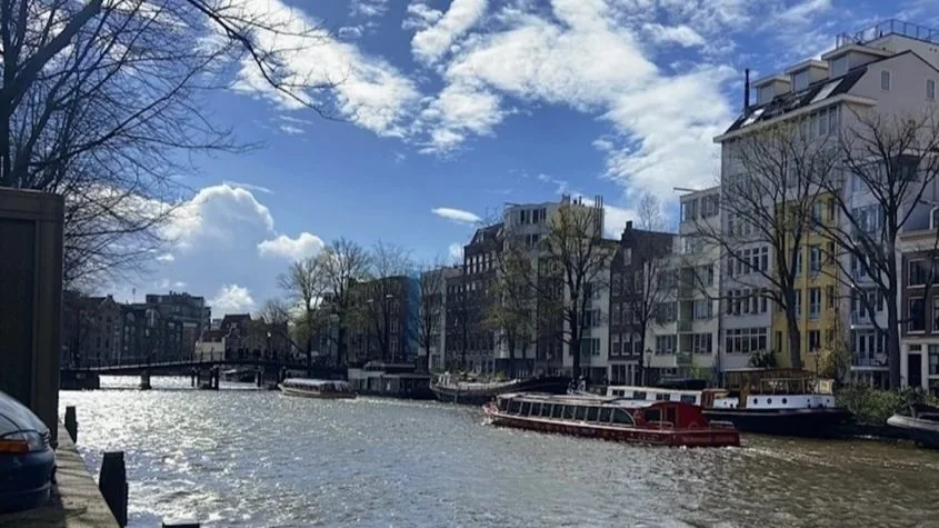 Tall, colourful narrow buildings line the streets of Amsterdam.