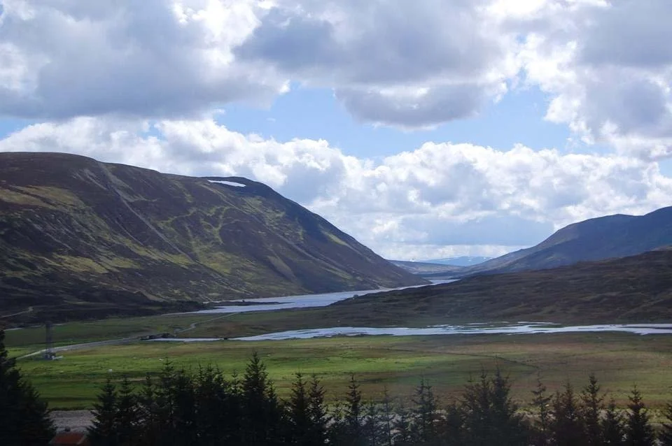 Rivers weave between mountains in the Scottish Highlands.