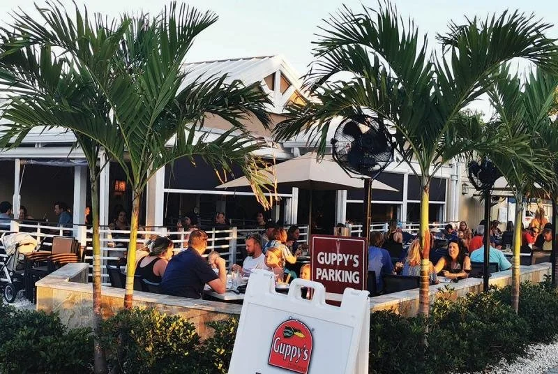 Crowds sit outside Guppy's on the Beach at Indian Rocks.