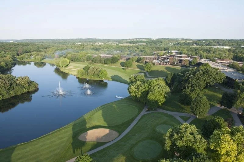 Green forests , golf trails and fountains stretch across the Grand Geneva Resort.