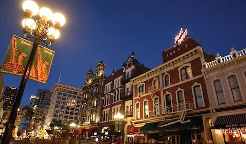 Lights of San Diego's historic Gaslamp quarter shine in the darkness.