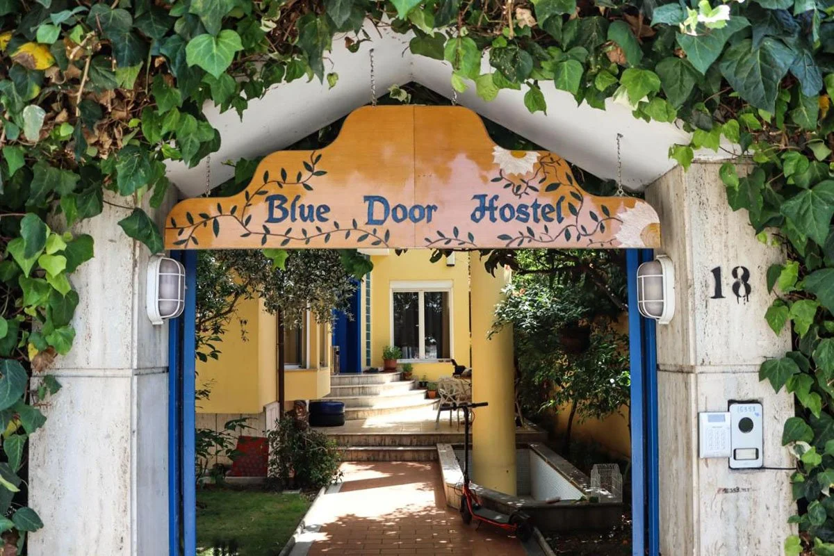 The charming entrance to Blue Door Hostel in Albania.