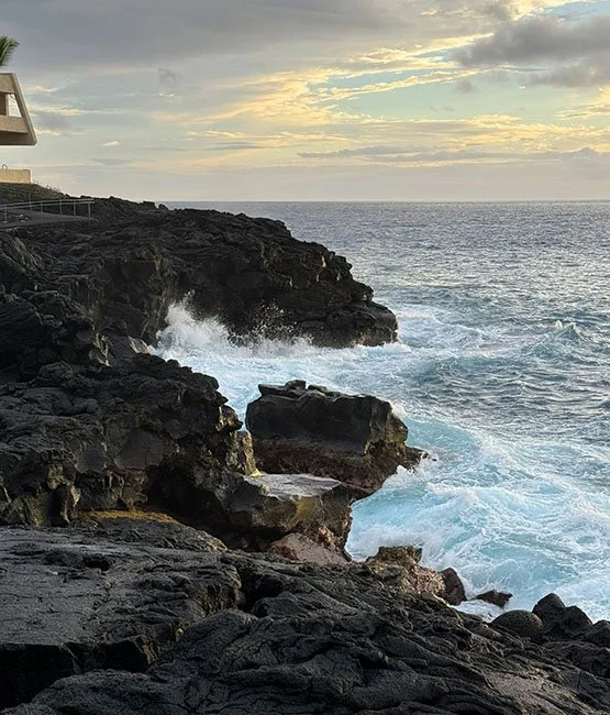 Waves crashing the volcanic rock shore of Outrigger Kona Resort & Spa