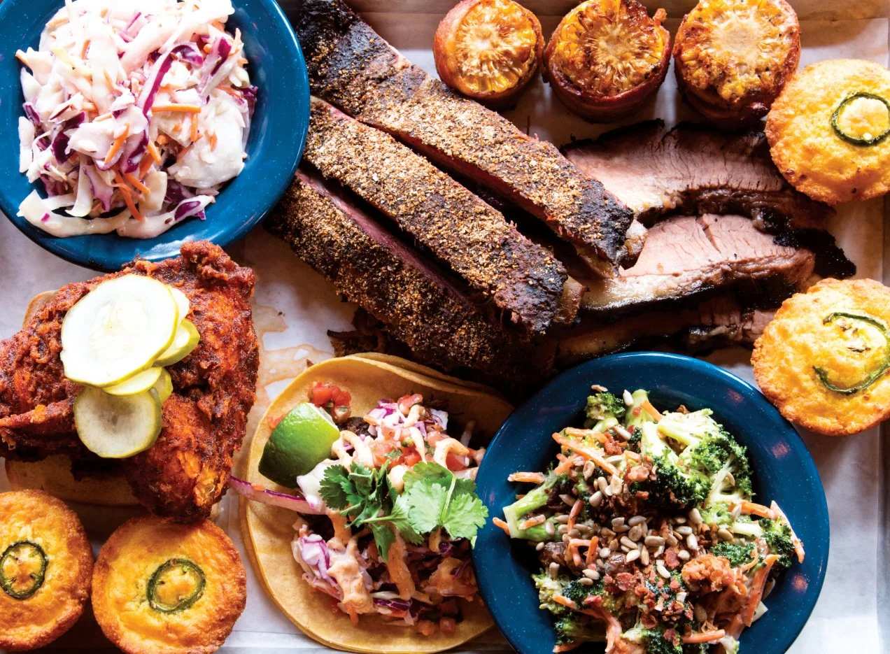 An array of classic barbecque dishes from fried chicken, brisket, corn bread to coleslaw from Commery Block Barbecue.