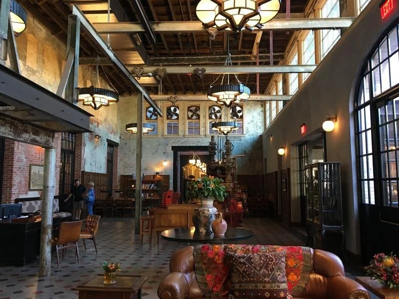 The colorful, quaint interior with chandeliers and furniture in the Hotel Emma.