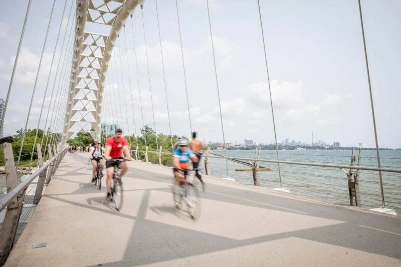 Cyclers make their way across the Humber Bay Arch Bridge.