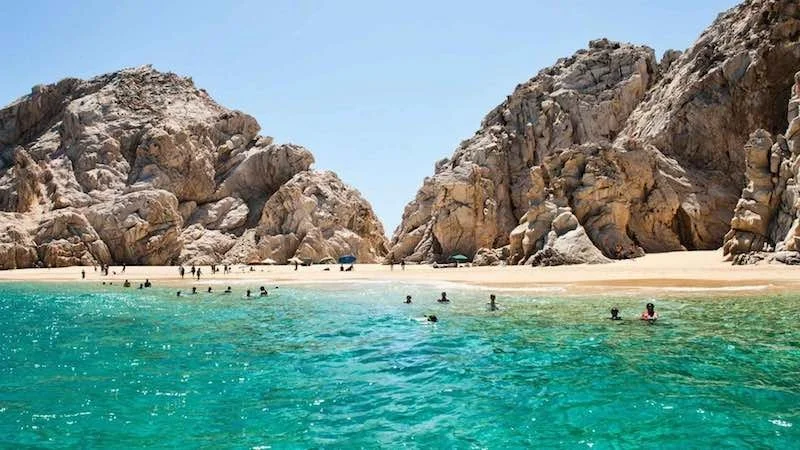 Crystal clear blue water and rocks in Cabo San Lucas, Mexico.