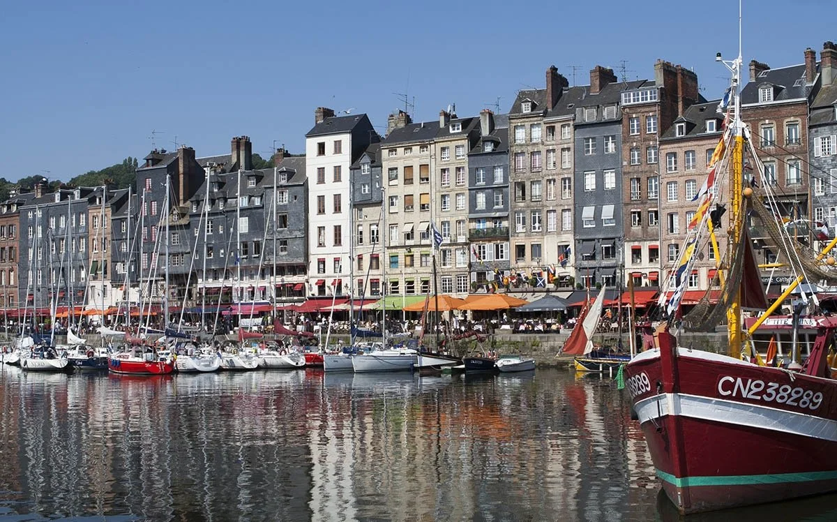 Boats and narrow houses line the old harbour in Honfleur.