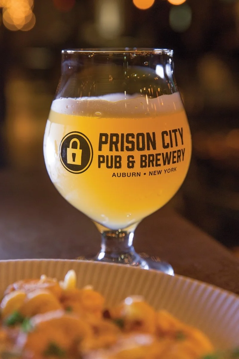 A logo with a lock from Prison City Pub & Brewery.