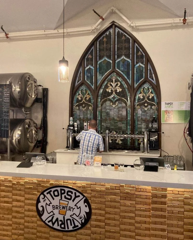 A man pours a beer at Topsy Turvey Brewery.