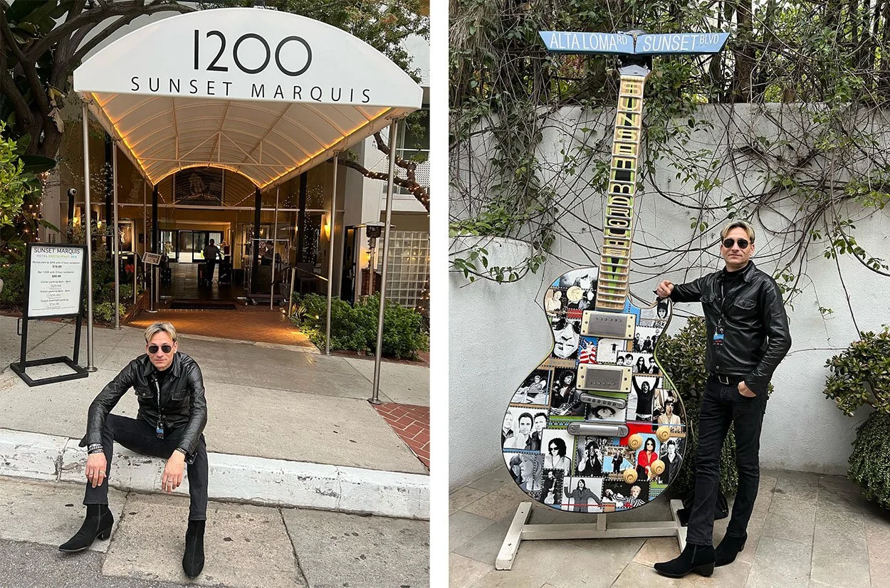 A man poses by a guitar out front of the Sunset Marquis.