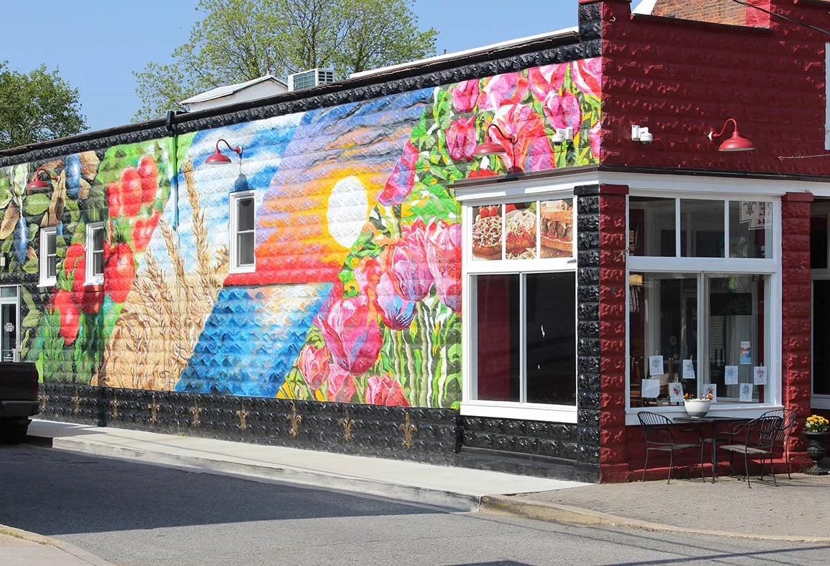 A bright mural on the side of a brick building in Denton.