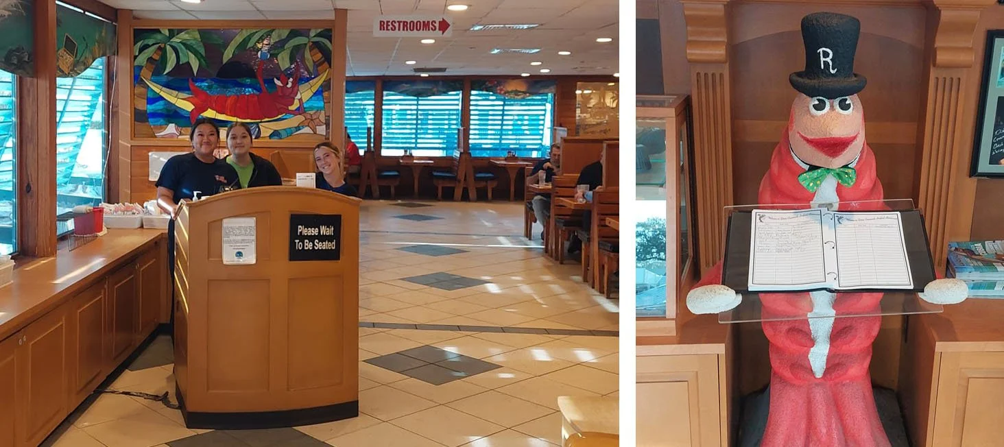 A shrimp at the Dixie Crossroads holds a guestbook.