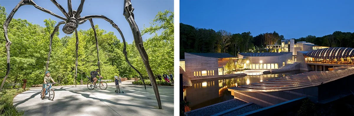 A family bikes below a spider statue and lights flicker during the evening at the Crystal Bridges Museum of American Art.