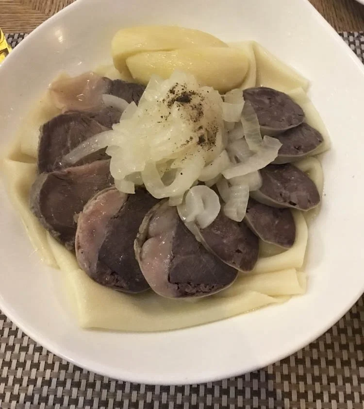 Horse meat and mutton lie upon a white plate.