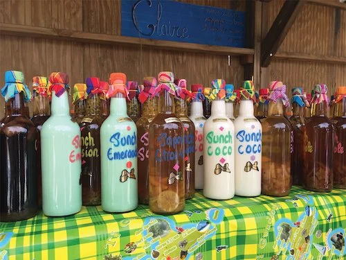 Bottles with coloured lids on a yellow and green checkered tablecloth.