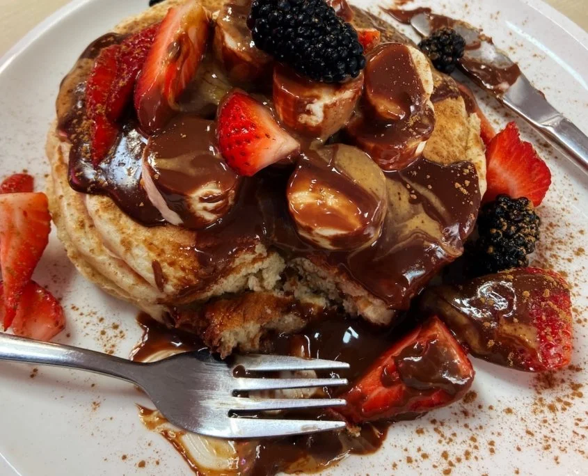 Pancakes covered with chocolate, strawberries and blackberries at MOAK Pancakes in Amsterdam.
