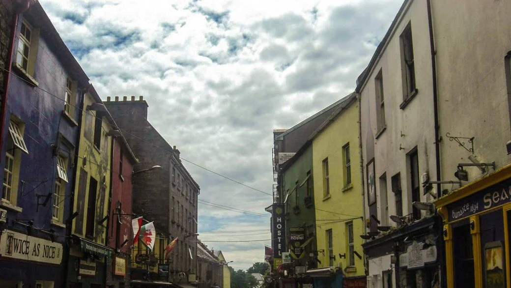 Colorful buildings of the old street in County Kerry during a cloudy day.