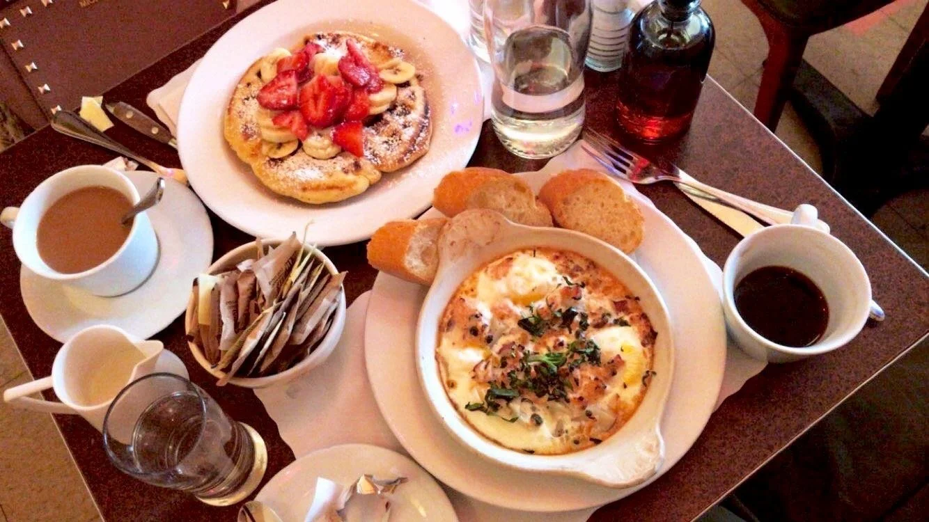 Strawberry pancakes, coffee and other dishes at a New York breakfast.