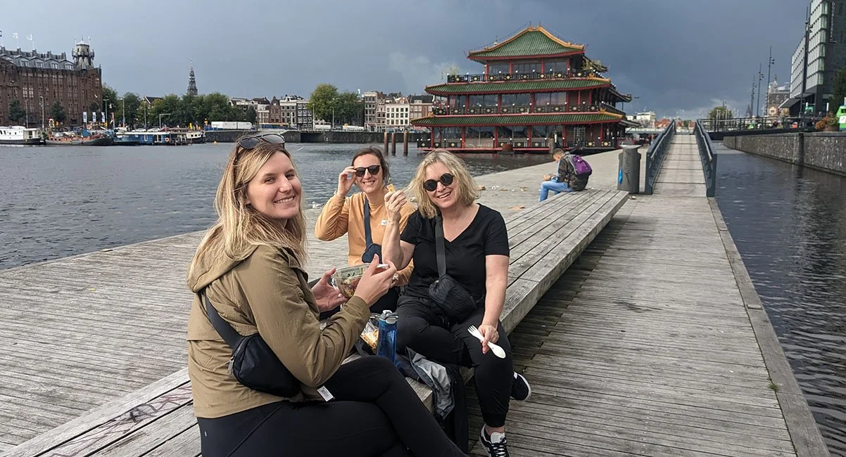 A group of tourists enjoy a cheap grocery store lunch while travelling Europe.