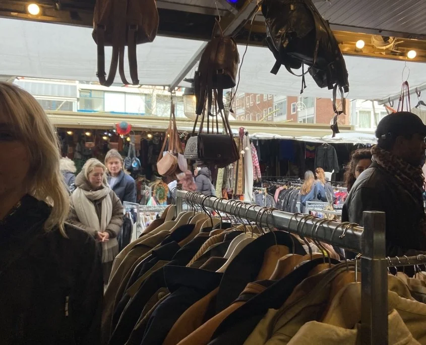 Visitors explore the Waterlooplein market in Amsterdam.