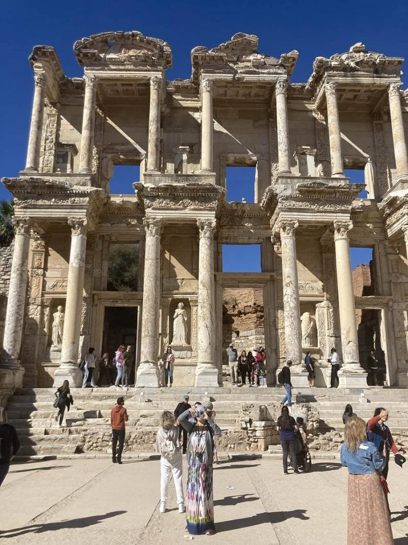 Tall, stacked columns of the Celcus Library tower over tourists.