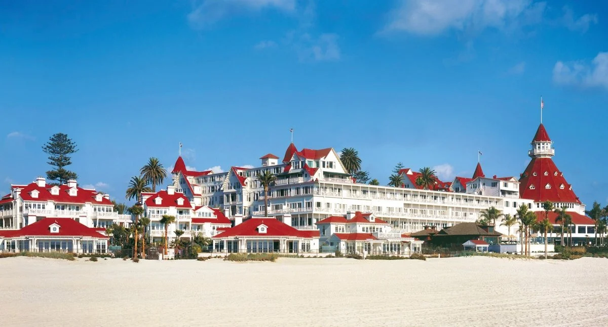 The expansive red and white exterior of the beachside Hotel del Coronado in San Diego.