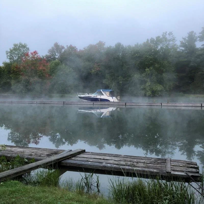 Morning mist surrounds a boat at Upper Brewers Lock.