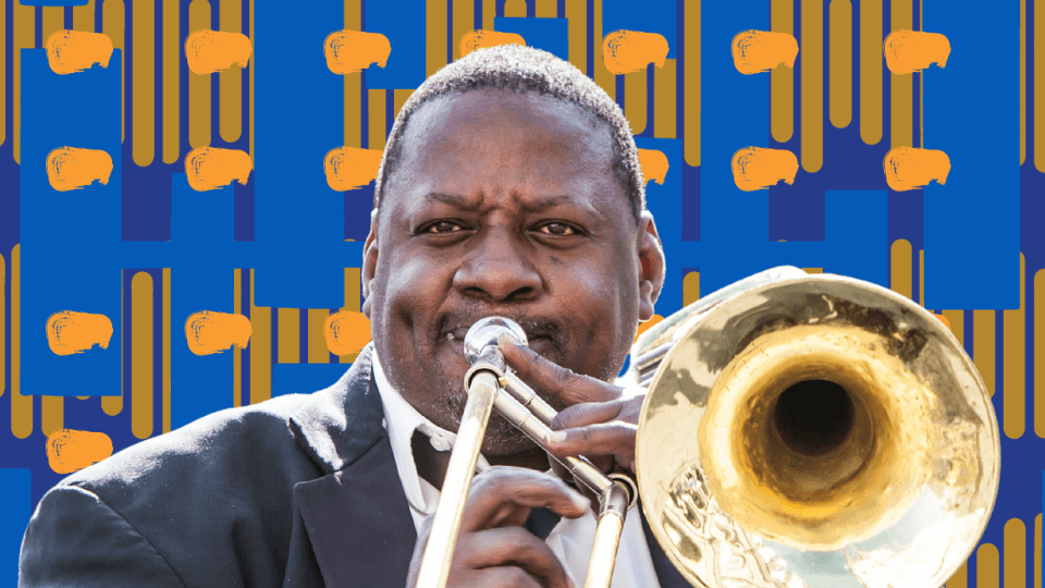 A person playing a trombone during an outdoor event with a group of musicians.