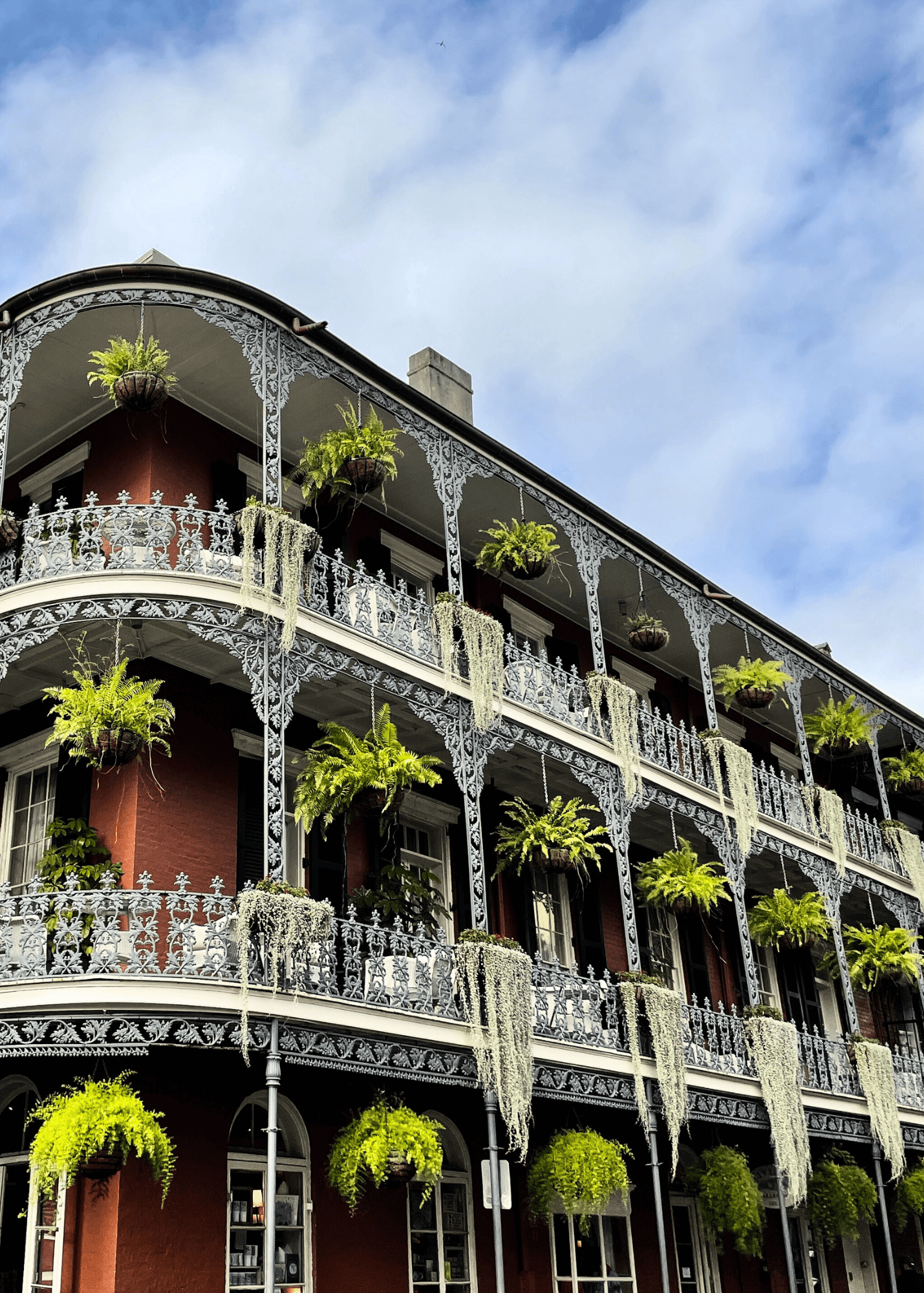 Historic French Quarter house with colorful shutters and wrought-iron balcony in New Orleans.
