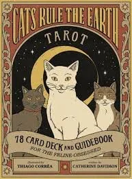 Tarot card deck titled 'Cats Rule the Earth' featuring three cats, a crescent moon, and stars, with the subtitle '78 Card Deck and Guidebook'.