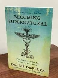 Book titled 'Becoming Supernatural' by Dr. Joe Dispenza, featuring a caduceus and palm tree illustration on the cover.