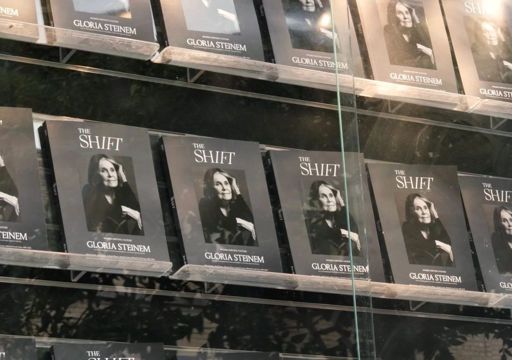 Bookshelf displaying copies of the book titled 'The Shift' by Gloria Steinem.