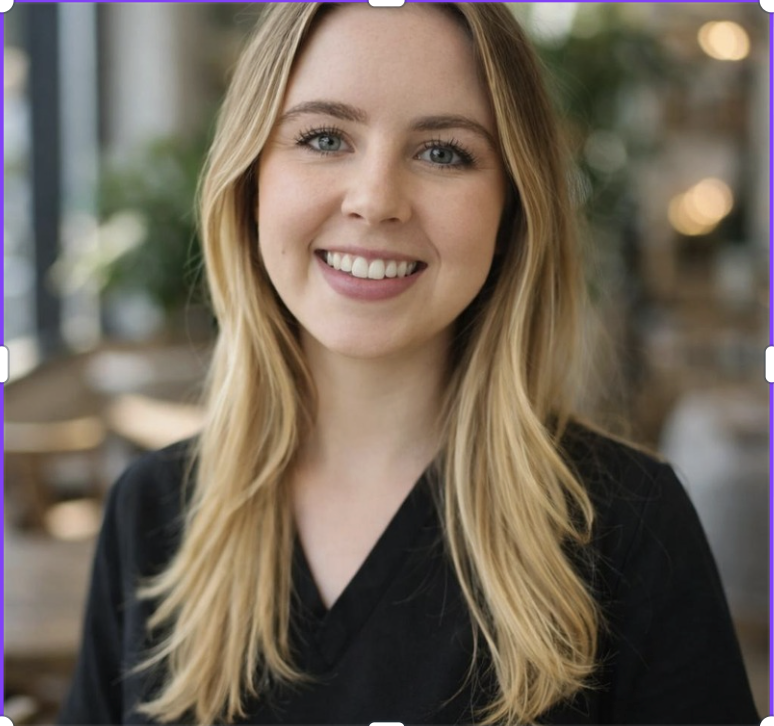 Portrait of a young woman Optometrist with long blonde hair smiling in a well-lit indoor space with blurred background.
