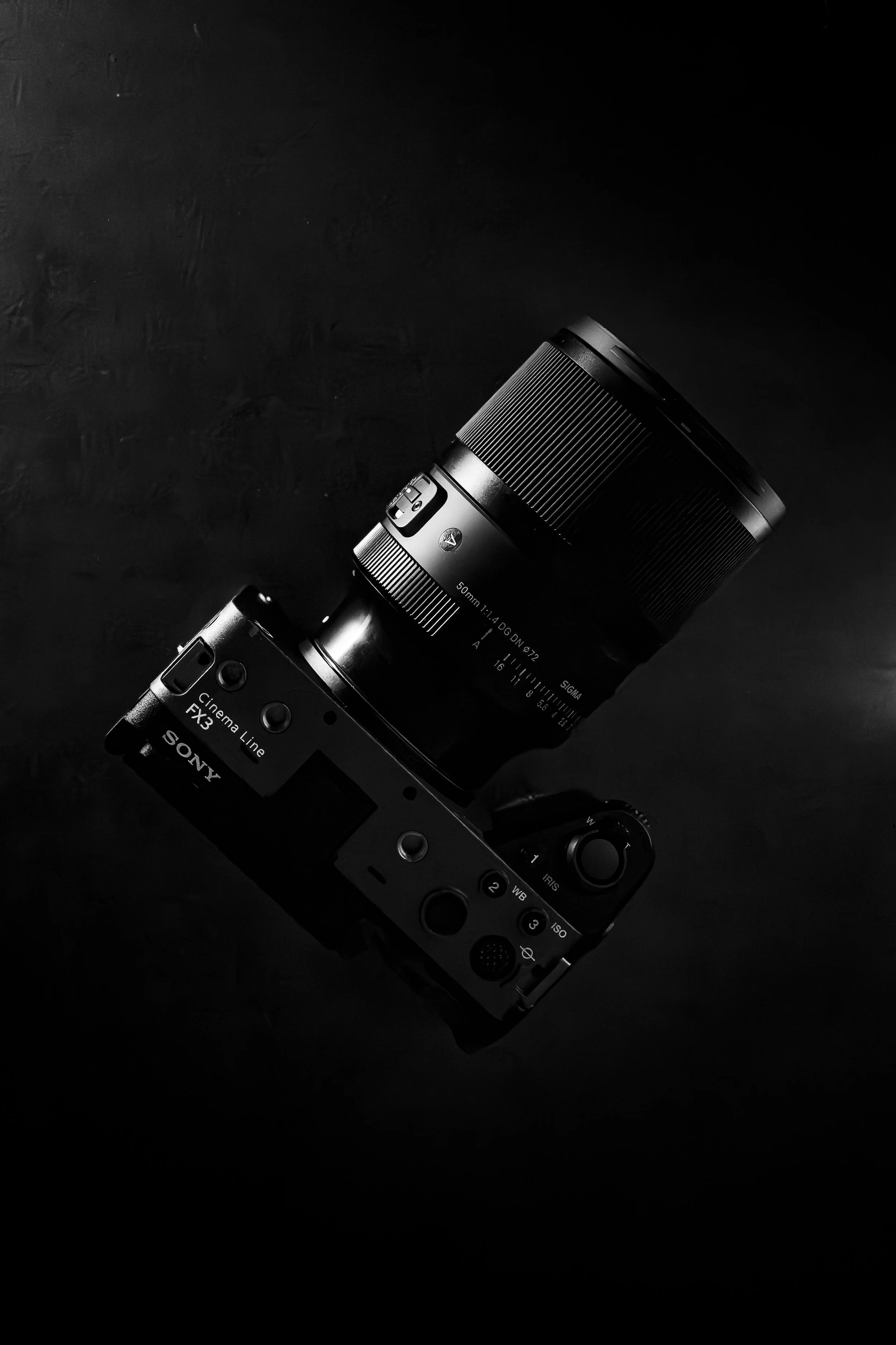 Black Sony camera with a large lens on a dark surface.