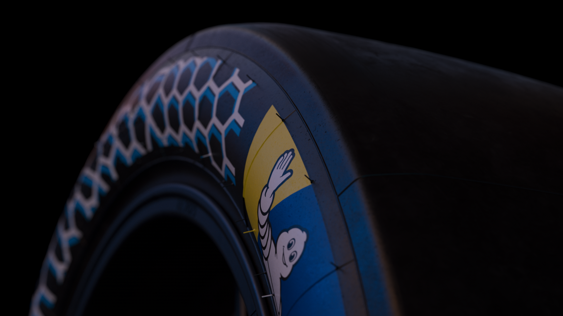 Nahaufnahme eines schwarzen Rads mit blauer und weißer Musterung und einem Sticker mit einem lächelnden Astronauten auf gelbem Hintergrund.