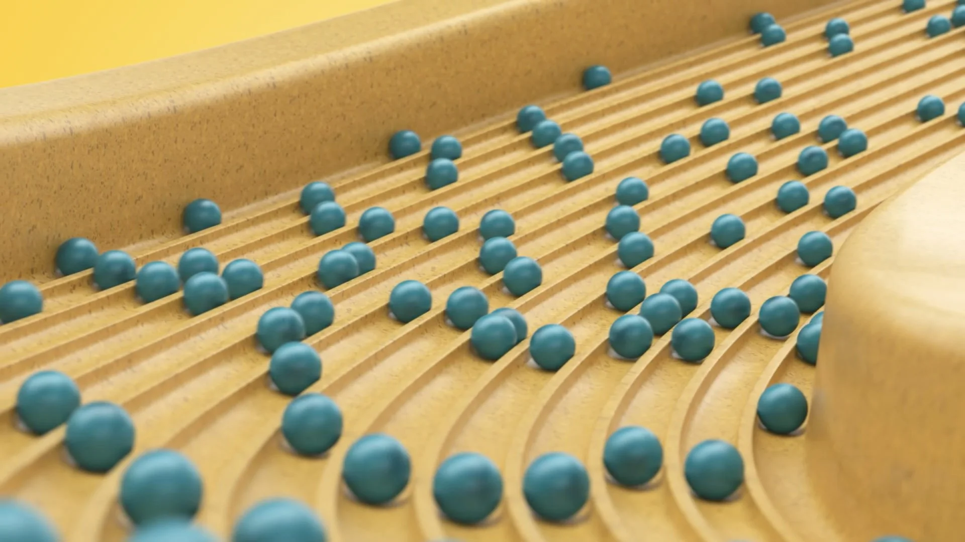 Blick auf eine Laufbahn mit blaue Bälle, die auf den Laufflächen platziert sind; vermutlich Teil eines Spiel- oder Labyrinths.