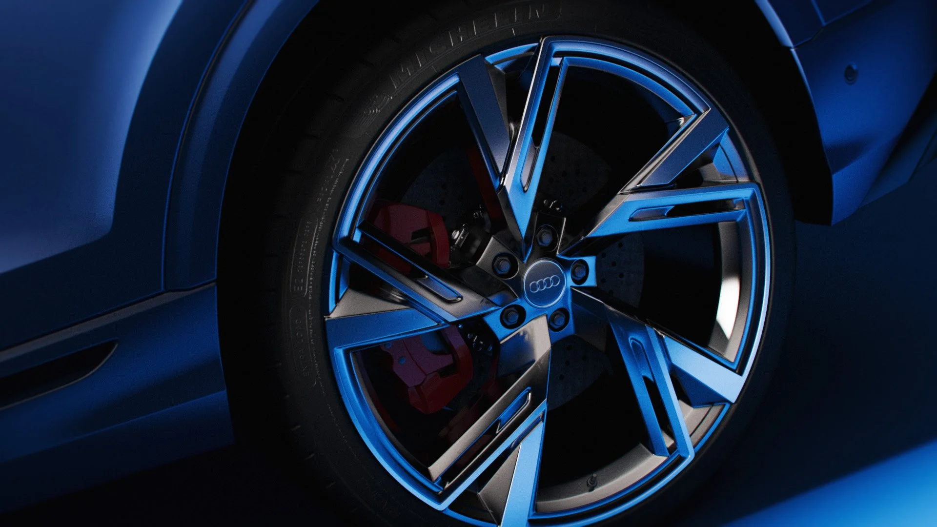 Nahaufnahme eines blauen Autos, Fokus auf das Rad mit Audi-Logo und blauer Felge, Schrauben sichtbar, Teil des Fahrzeugkörpers