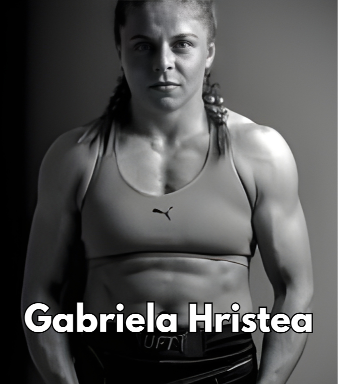 Black and white photo of Gabriela Hristae, a female athlete with a muscular build, wearing a sports bra and athletic shorts, standing confidently with a serious expression.