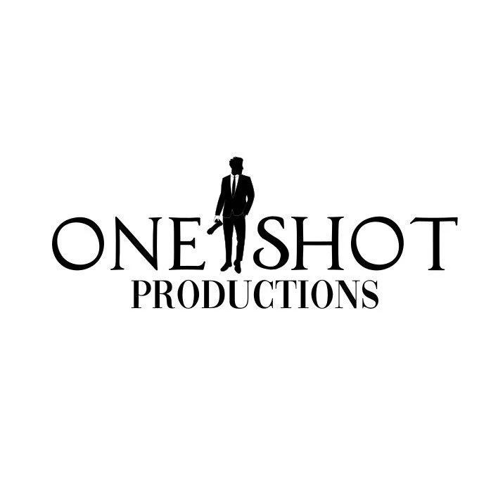 Logo for One Shot Productions featuring a silhouette of a man in a suit holding a gun.