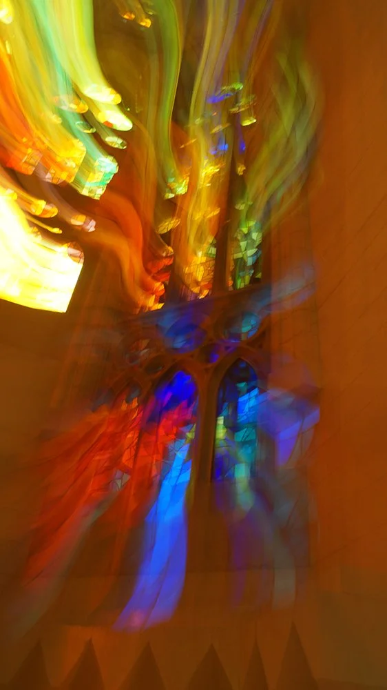 Abstract, colorful lights and stained-glass window in a blur, creating a vibrant, artistic effect.