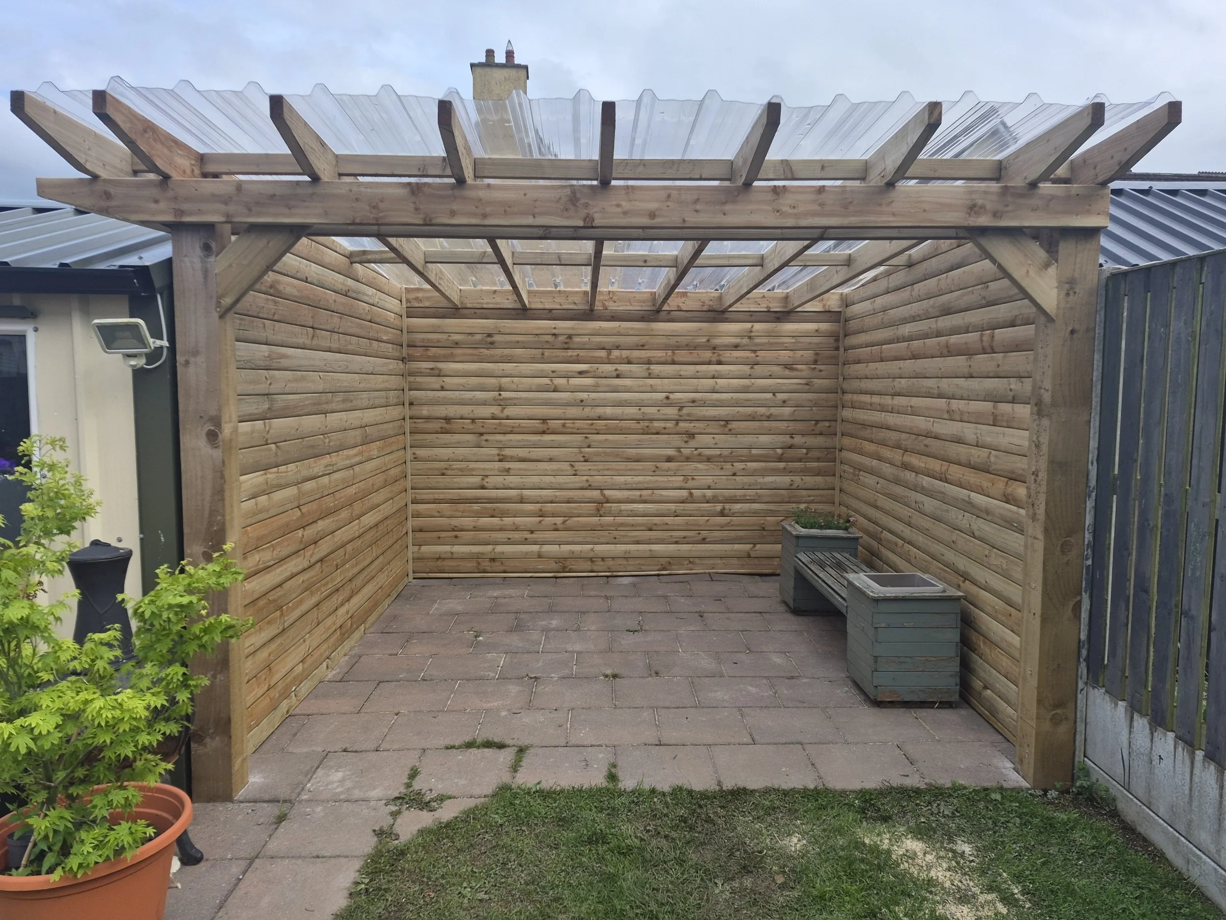 Compact Standalone Pergola with Three Cladded Walls