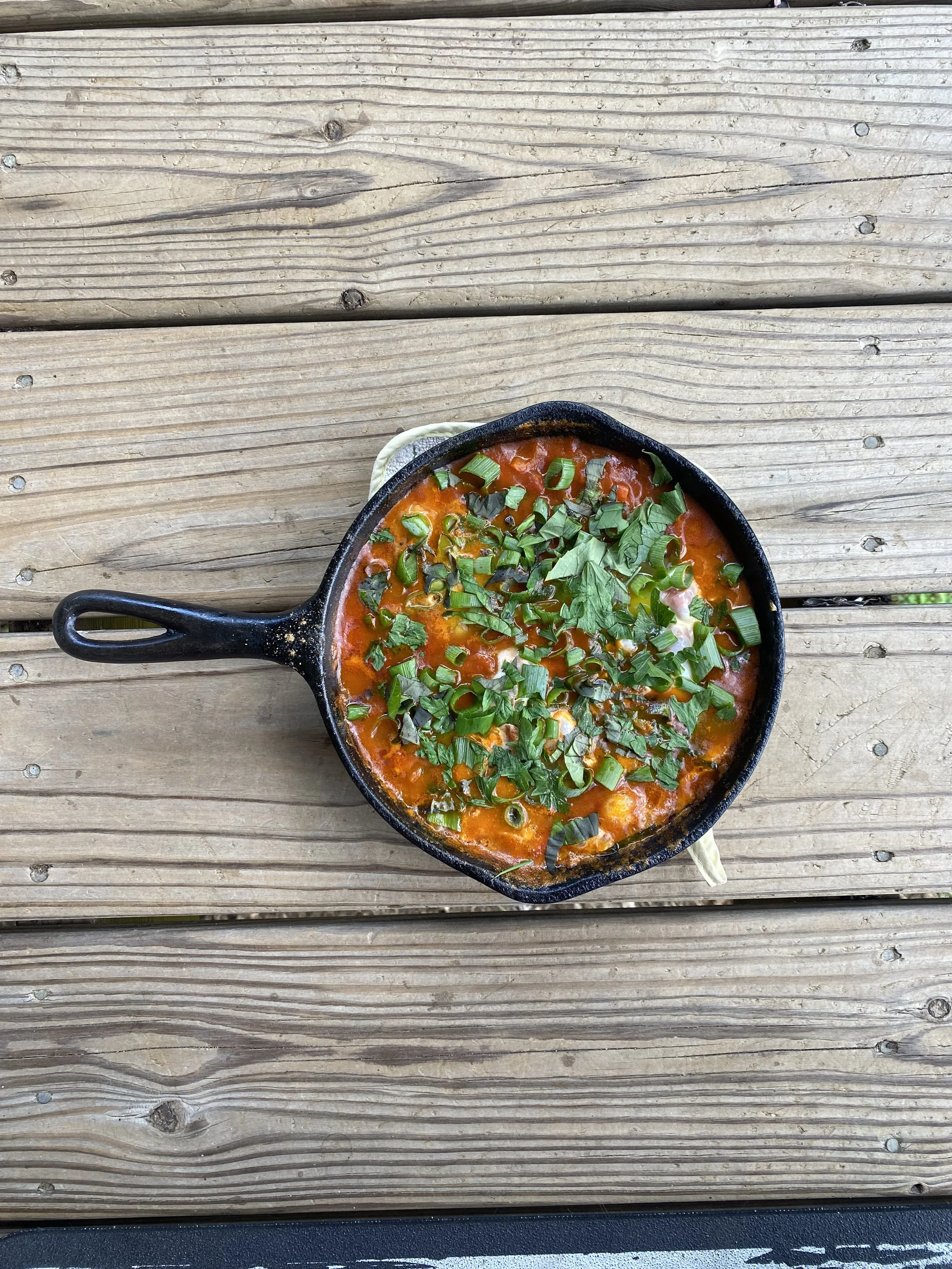 shakshuka with a ton of culinary herbs - parsley, basil