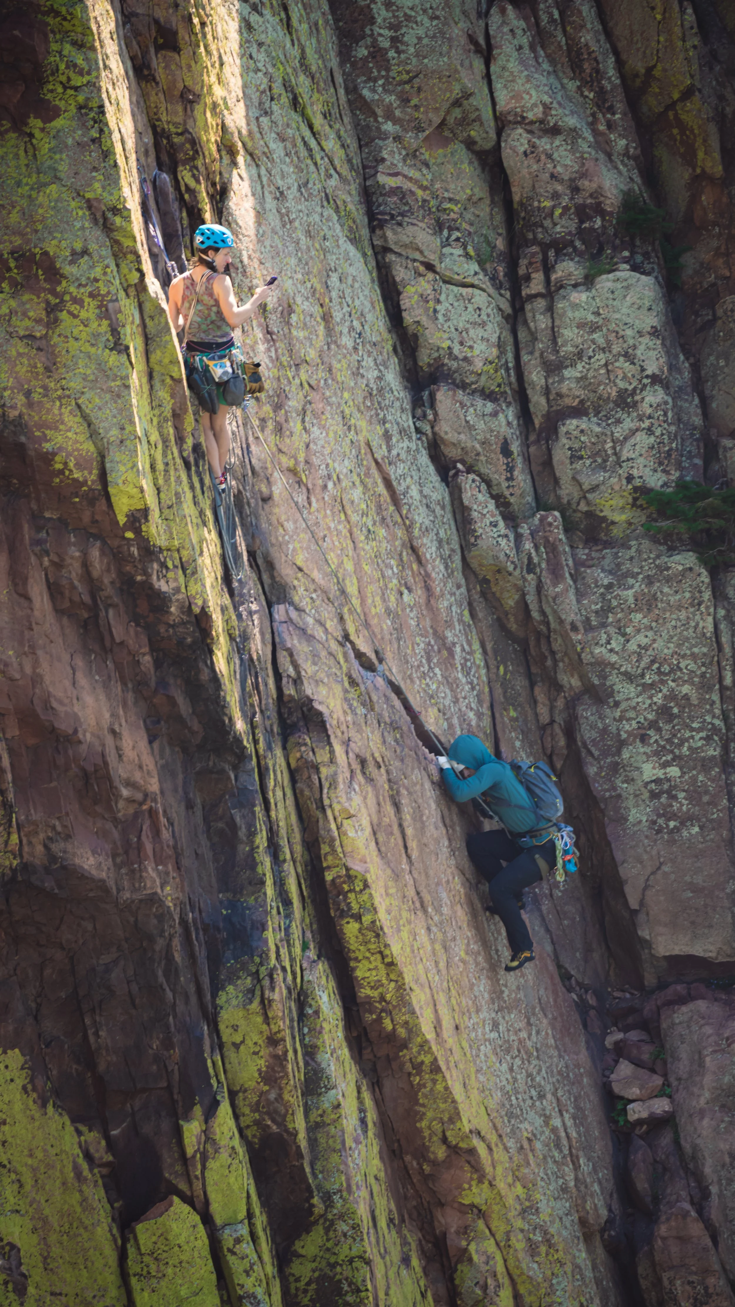 Becca Droz guiding her client, and photographing, while he works through the cruz of Rewritten, Eldorado Canyon State Park, CO.