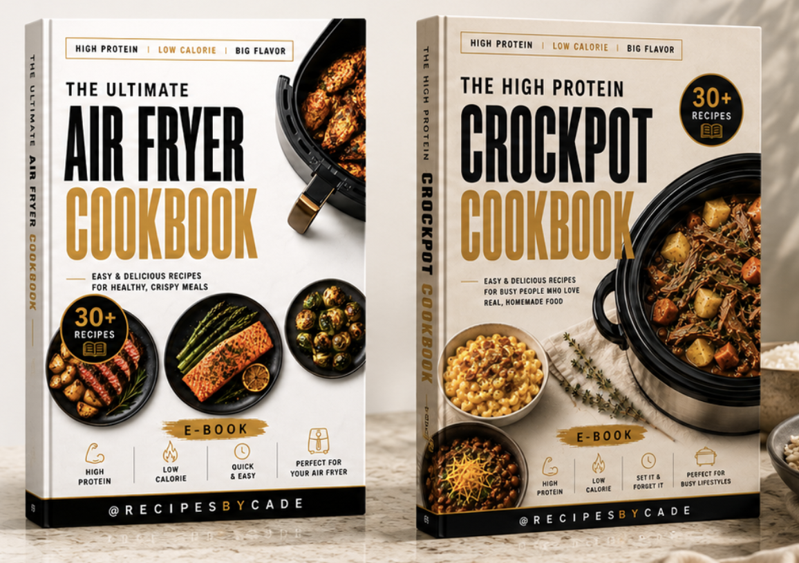 Open cookbook displaying lunch recipes with vibrant salads and dishes, surrounded by fresh green leafy lettuce on white surface, with green paper clip at top
